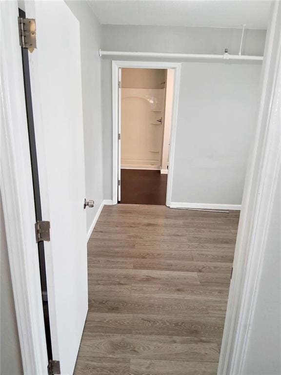 hall with wood finished floors and baseboards