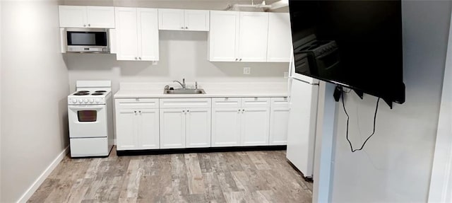 kitchen featuring white electric range, a sink, white cabinetry, light countertops, and stainless steel microwave