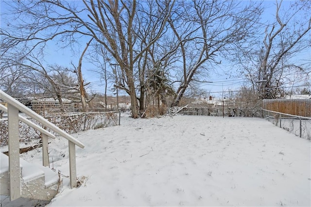 yard layered in snow with fence