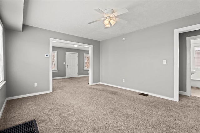 unfurnished room featuring baseboards and carpet floors