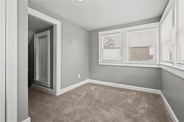 empty room with baseboards, carpet floors, and a healthy amount of sunlight