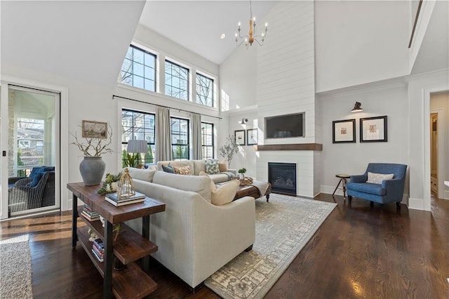 living area with dark wood-style floors, a fireplace, and a wealth of natural light