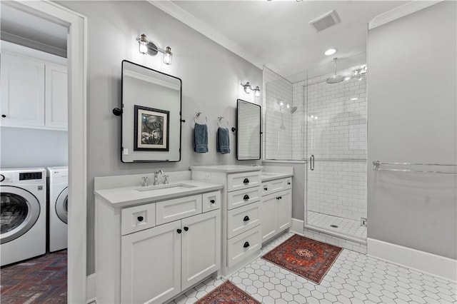 bathroom with visible vents, independent washer and dryer, a stall shower, and vanity