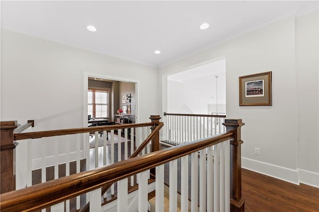 hall featuring crown molding, baseboards, an upstairs landing, recessed lighting, and dark wood-style flooring