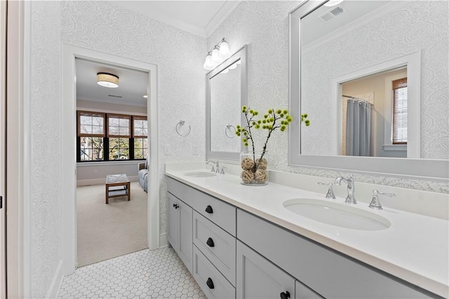 full bathroom featuring double vanity, visible vents, ornamental molding, and a sink