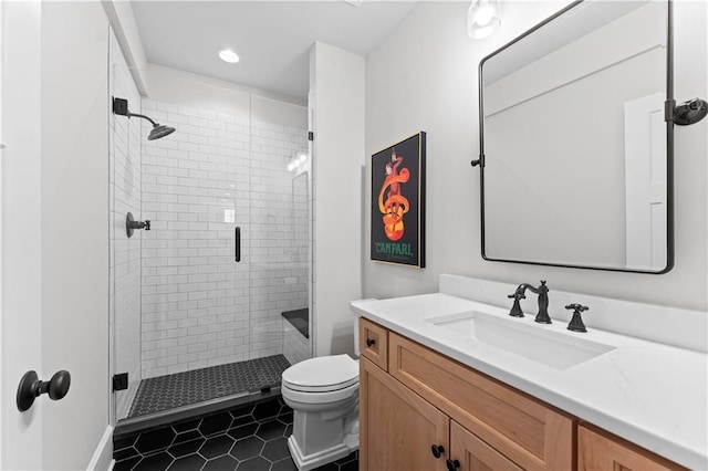 bathroom with vanity, tile patterned floors, toilet, and a stall shower