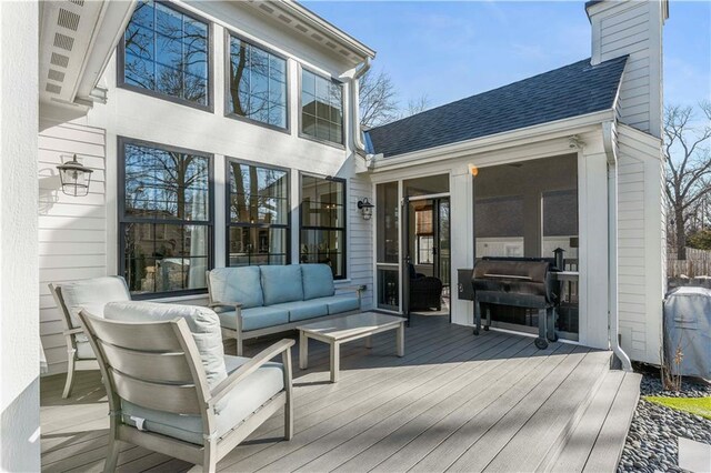 deck featuring an outdoor living space and area for grilling