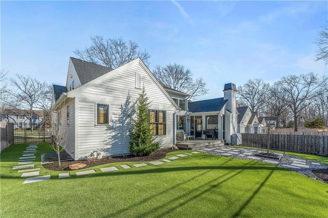 rear view of property with a yard, fence, and a wooden deck