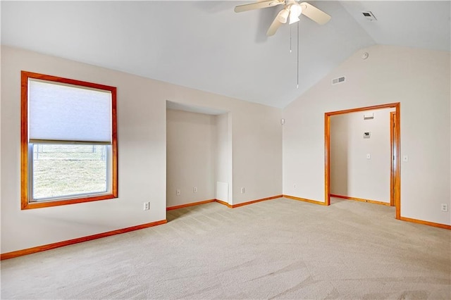 unfurnished room with a ceiling fan, baseboards, visible vents, vaulted ceiling, and light colored carpet