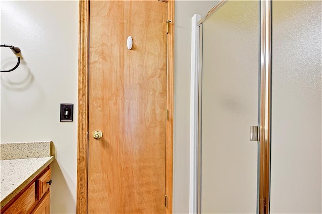 full bathroom featuring a stall shower and vanity