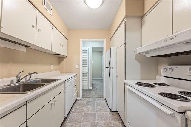 kitchen featuring white appliances, visible vents, a sink, white cabinets, and under cabinet range hood