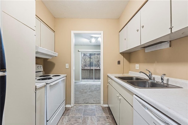 kitchen with white appliances, a sink, light countertops, under cabinet range hood, and white cabinetry