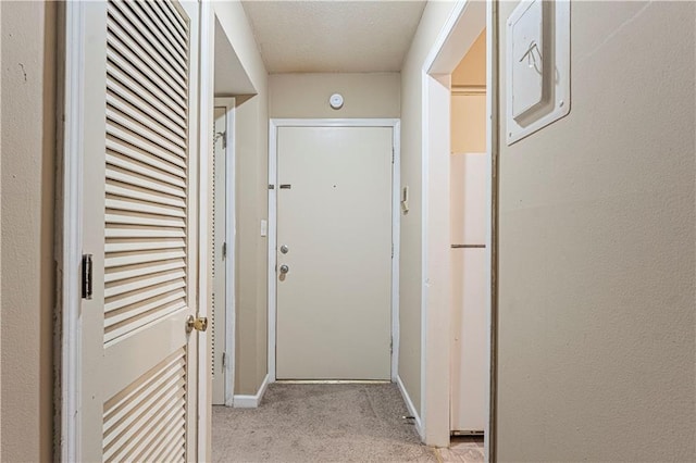 hallway featuring light colored carpet