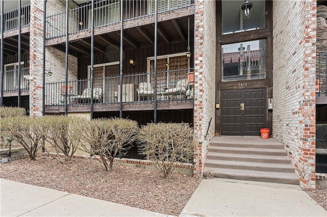 property entrance featuring brick siding