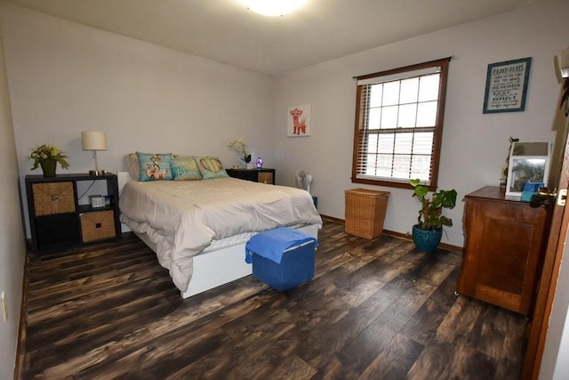 bedroom featuring baseboards and wood finished floors