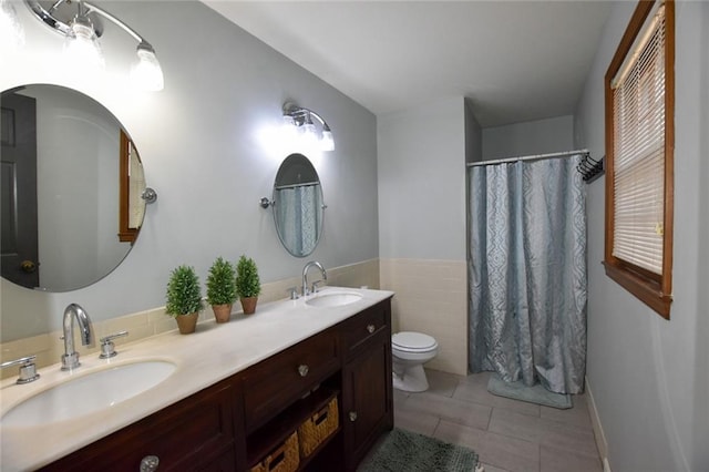 bathroom featuring a sink, toilet, double vanity, and tile patterned flooring