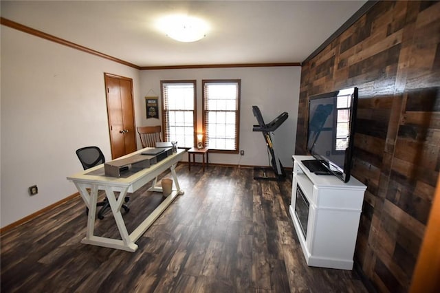 office with dark wood-style floors, wooden walls, crown molding, and baseboards