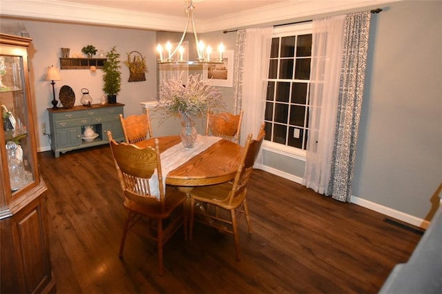 dining space with a chandelier, crown molding, baseboards, and wood finished floors