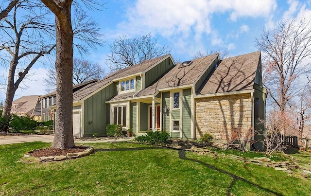 view of front of home with a front yard, driveway, a garage, stone siding, and board and batten siding