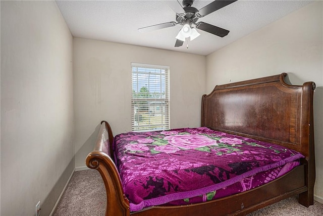 bedroom with carpet, ceiling fan, a textured ceiling, and baseboards