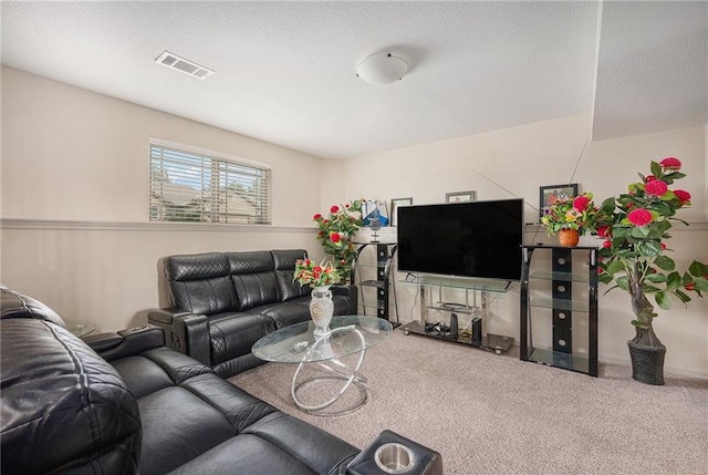 carpeted living area featuring a textured ceiling and visible vents