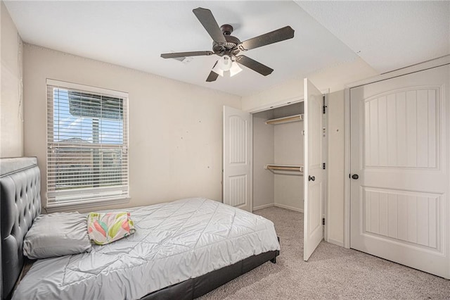 bedroom featuring a ceiling fan, light colored carpet, and baseboards