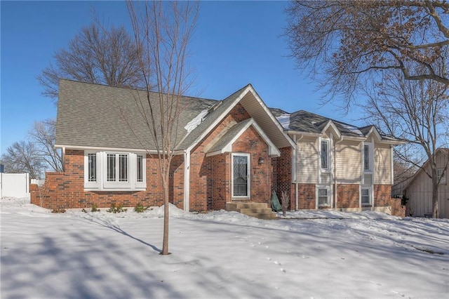 view of front of property with fence and brick siding