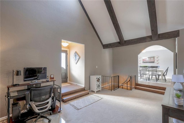 office area with vaulted ceiling with beams, carpet floors, and arched walkways