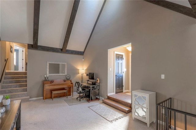 interior space featuring baseboards, high vaulted ceiling, and beam ceiling