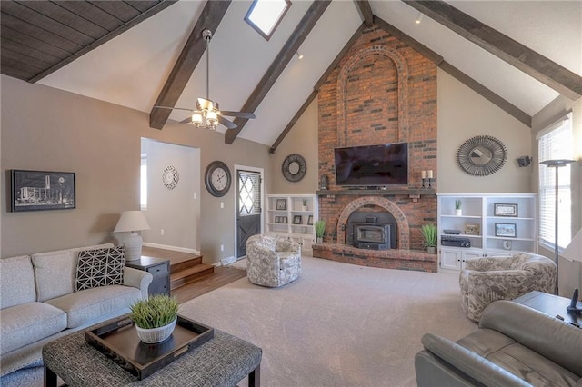 carpeted living room with a healthy amount of sunlight, baseboards, high vaulted ceiling, and beam ceiling