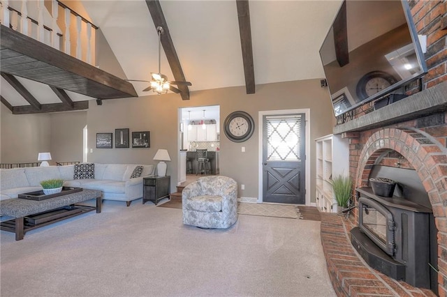 carpeted living room with high vaulted ceiling, a wood stove, beam ceiling, and a ceiling fan