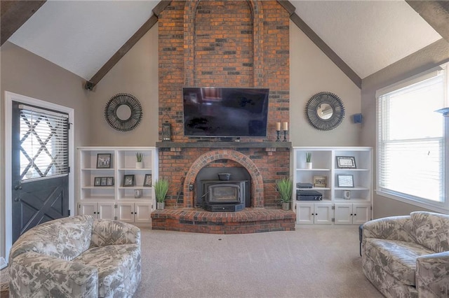 carpeted living room with high vaulted ceiling and a wood stove