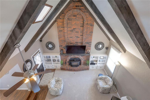 unfurnished living room featuring high vaulted ceiling, wood finished floors, baseboards, beam ceiling, and a wood stove