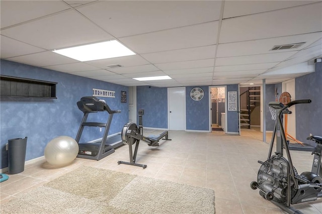 workout area featuring a paneled ceiling, baseboards, and visible vents