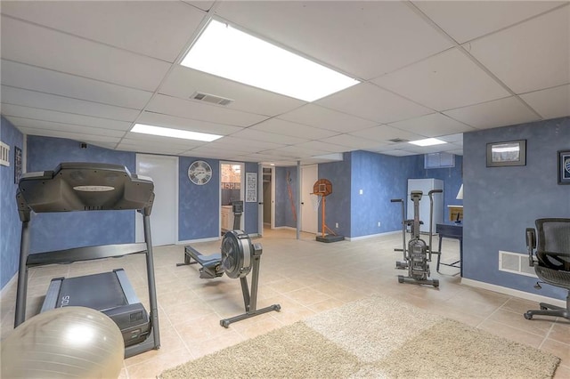 workout room featuring baseboards, visible vents, and a drop ceiling