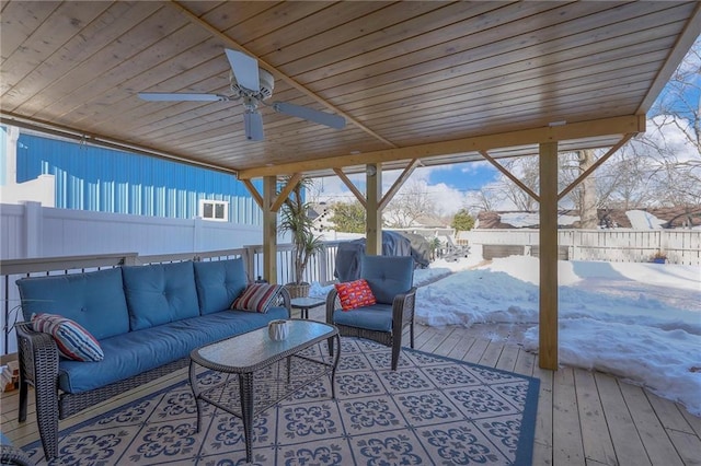 wooden deck featuring a ceiling fan, outdoor lounge area, and fence