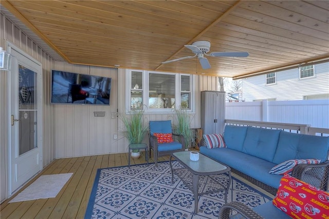 sunroom / solarium with wood ceiling and ceiling fan