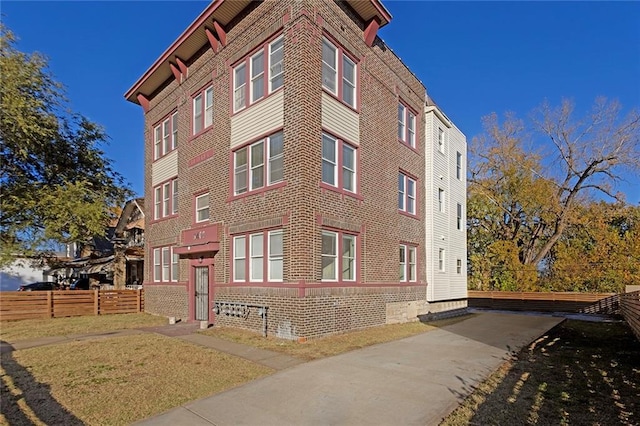 view of building exterior with fence