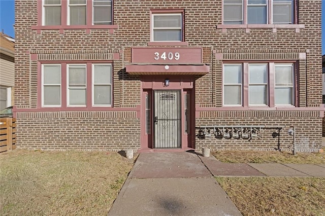 entrance to property with brick siding