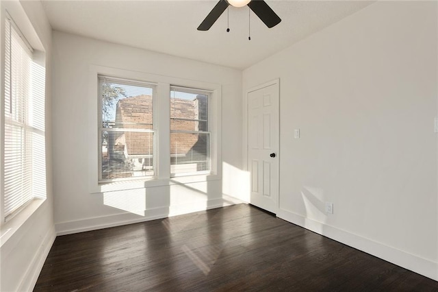 unfurnished room featuring wood finished floors, a ceiling fan, and baseboards