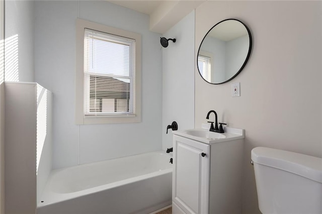 bathroom featuring toilet, a bath, and vanity