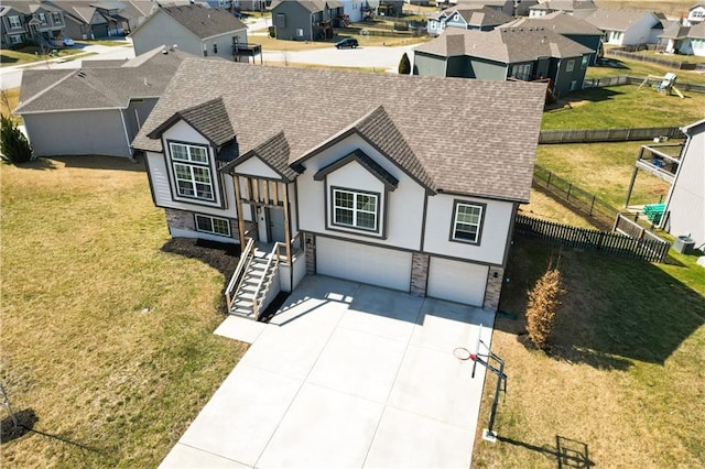 view of front of house with a shingled roof, fence, a residential view, concrete driveway, and a garage