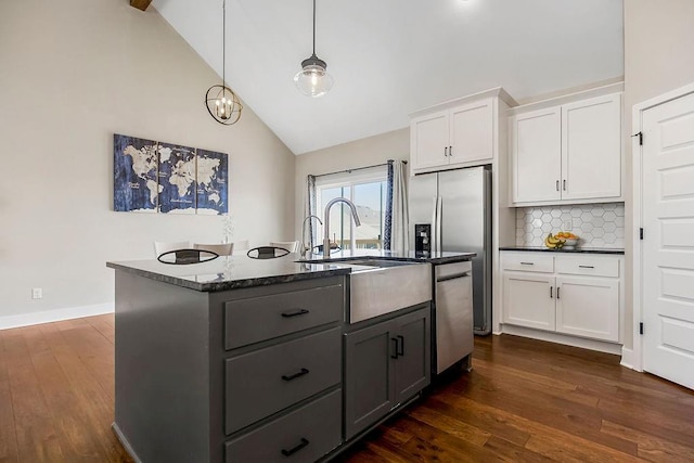 kitchen with dark wood finished floors, a center island with sink, dishwasher, and white cabinetry