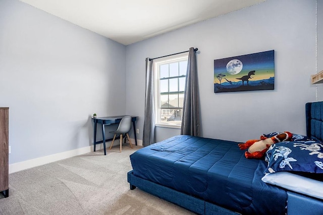 bedroom with baseboards and carpet