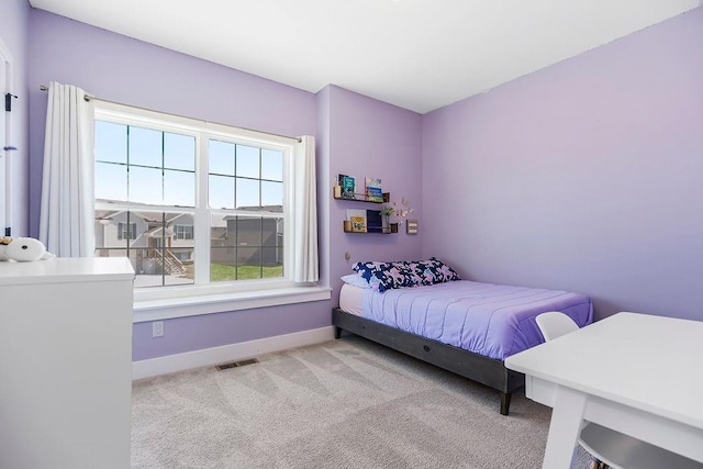 carpeted bedroom with baseboards and visible vents