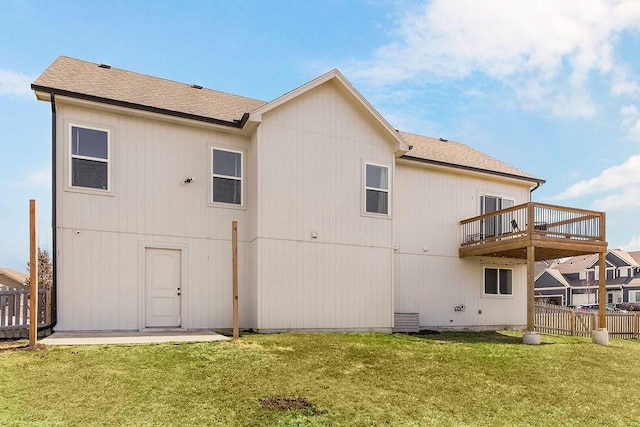 back of house with a yard and fence