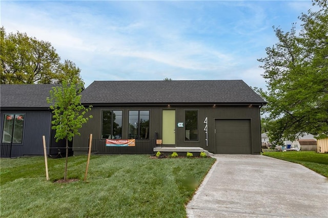 4413 E 135th St, Grandview, MO 64030 - view of front of house featuring an attached garage, concrete driveway, a front lawn, and a shingled roof