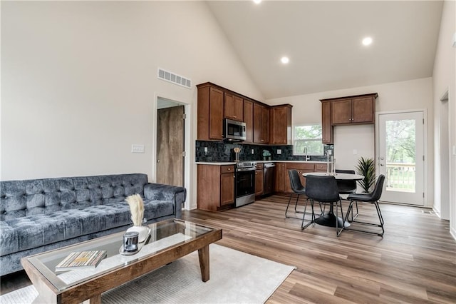 4413 E 135th St, Grandview, MO 64030 - living area with high vaulted ceiling, recessed lighting, and light wood finished floors