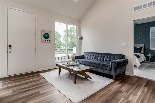 4413 E 135th St, Grandview, MO 64030 - living room with wood finished floors, healthy amount of natural light, high vaulted ceiling, and baseboards