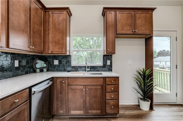 4413 E 135th St, Grandview, MO 64030 - kitchen featuring stainless steel dishwasher, a sink, wood finished floors, and decorative backsplash